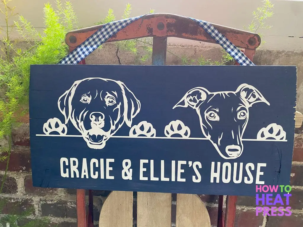 blue wood sign featuring white dogs