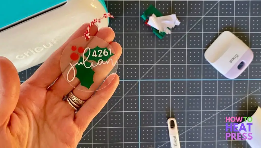 acrylic ornament with green holly leaves, red berries, and street address