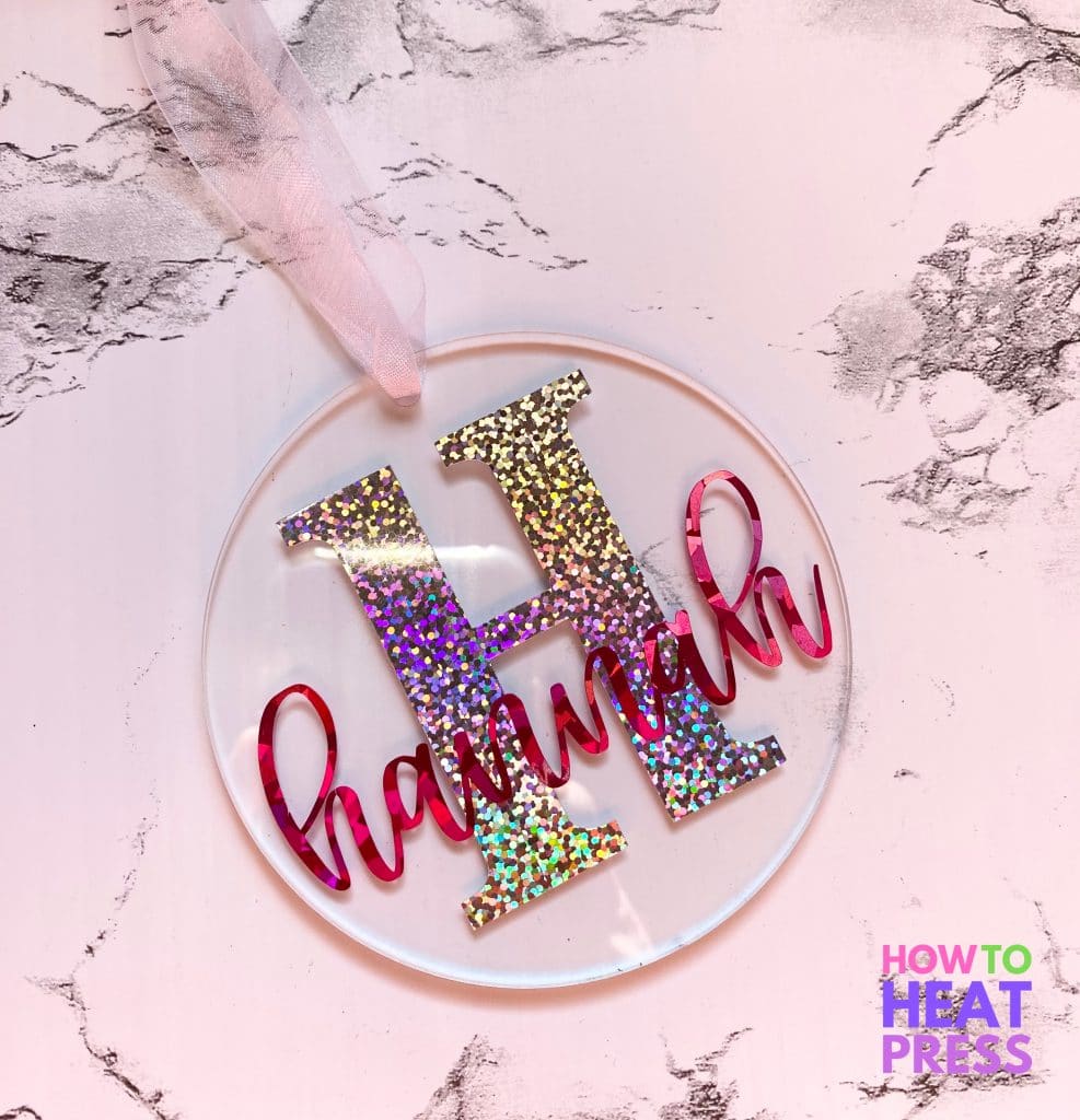clear acrylic ornament with 'H' in glitter vinyl and the name hannah in pink