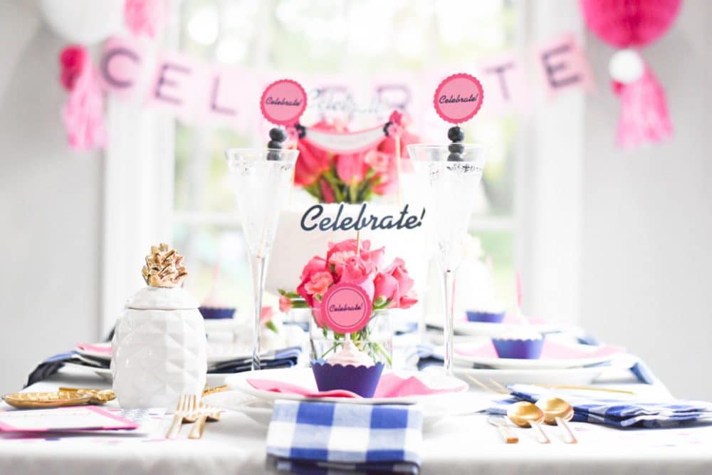 table with pink, blue and white "celebrate" party decorations