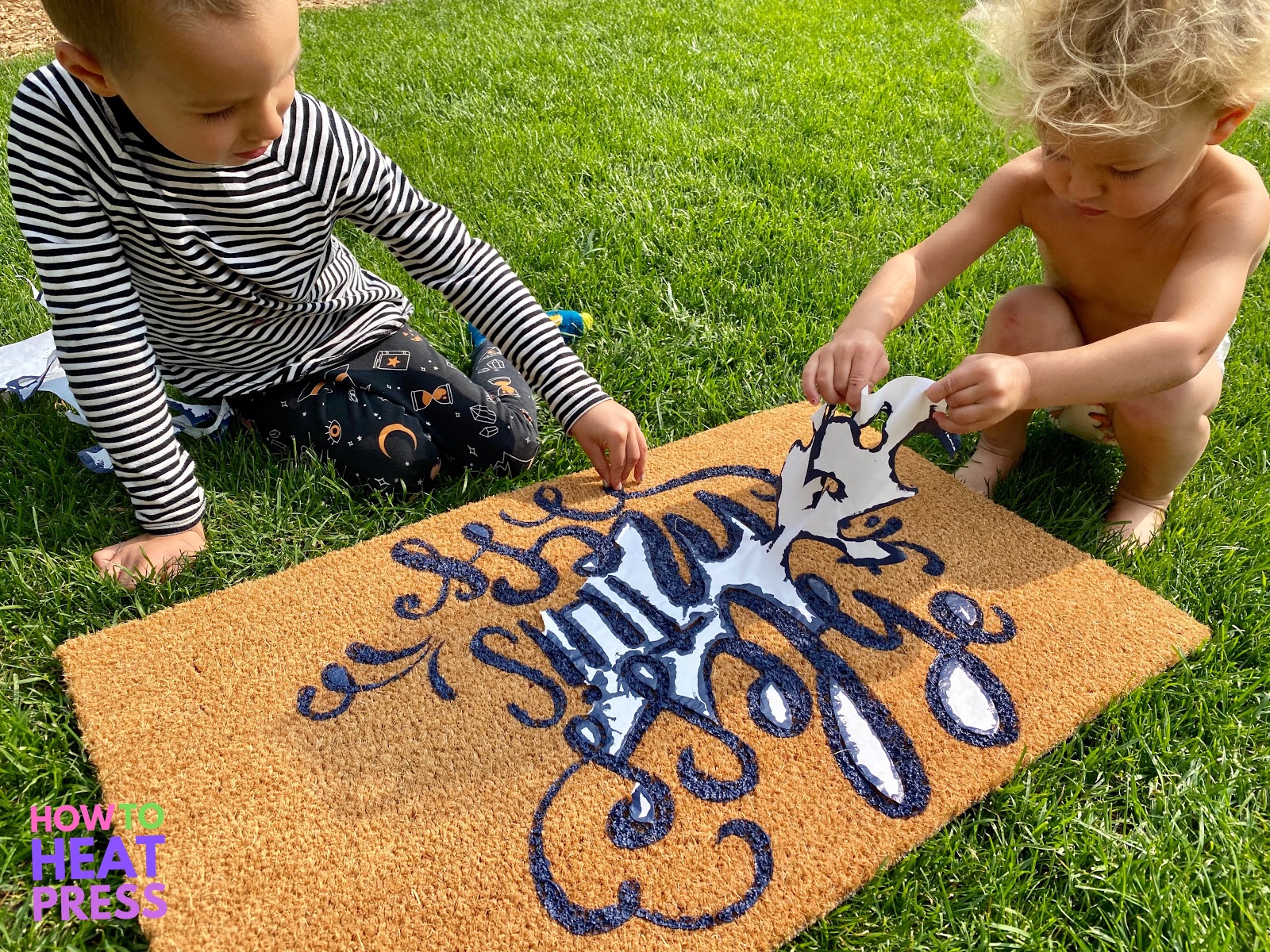 children peeling freezer paper stencil on diy doormat