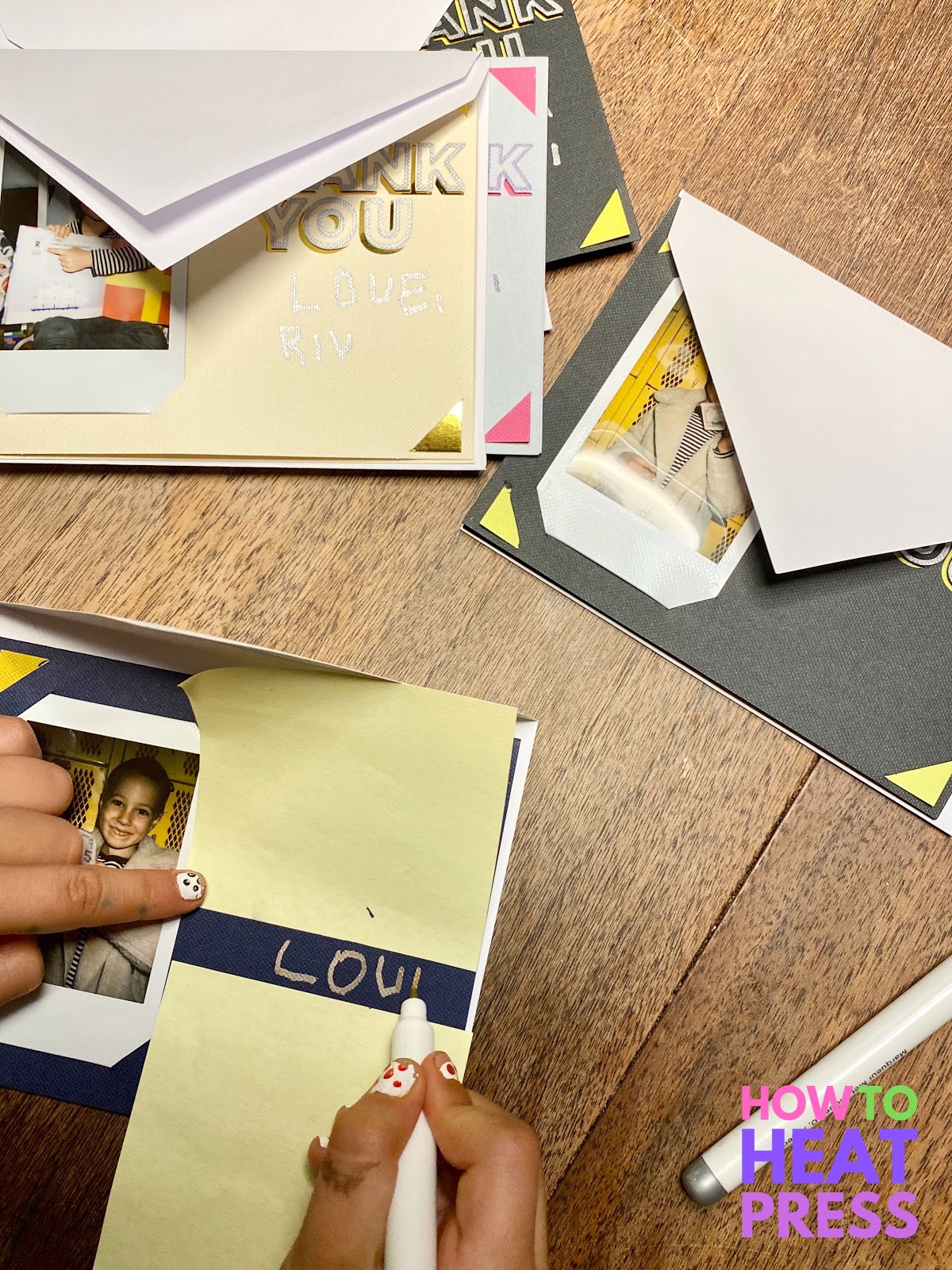 child writing 'love' on diy thank you cards with photos