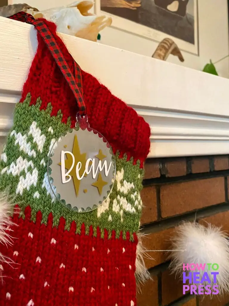 red and green knitted stocking with white snowflakes and personalized acrylic ornament