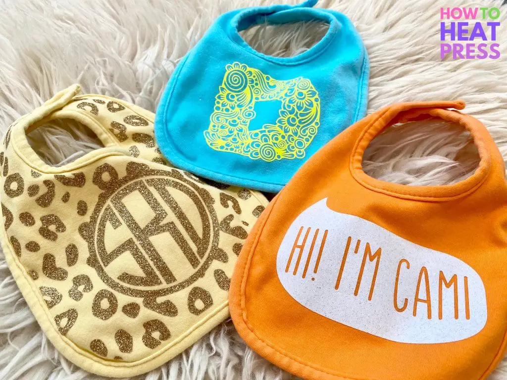 blue, yellow, and orange baby bibs customized with htv