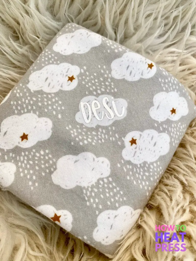 gray baby blanket with white clouds and baby's name in silver