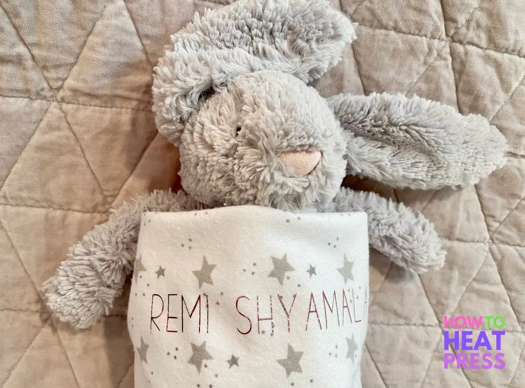 gray bunny in swaddle blanket with stars and pink baby name.JPG