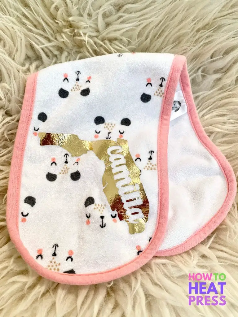 white and pink burp cloth with animal faces and baby's name cut out of the shape of florida