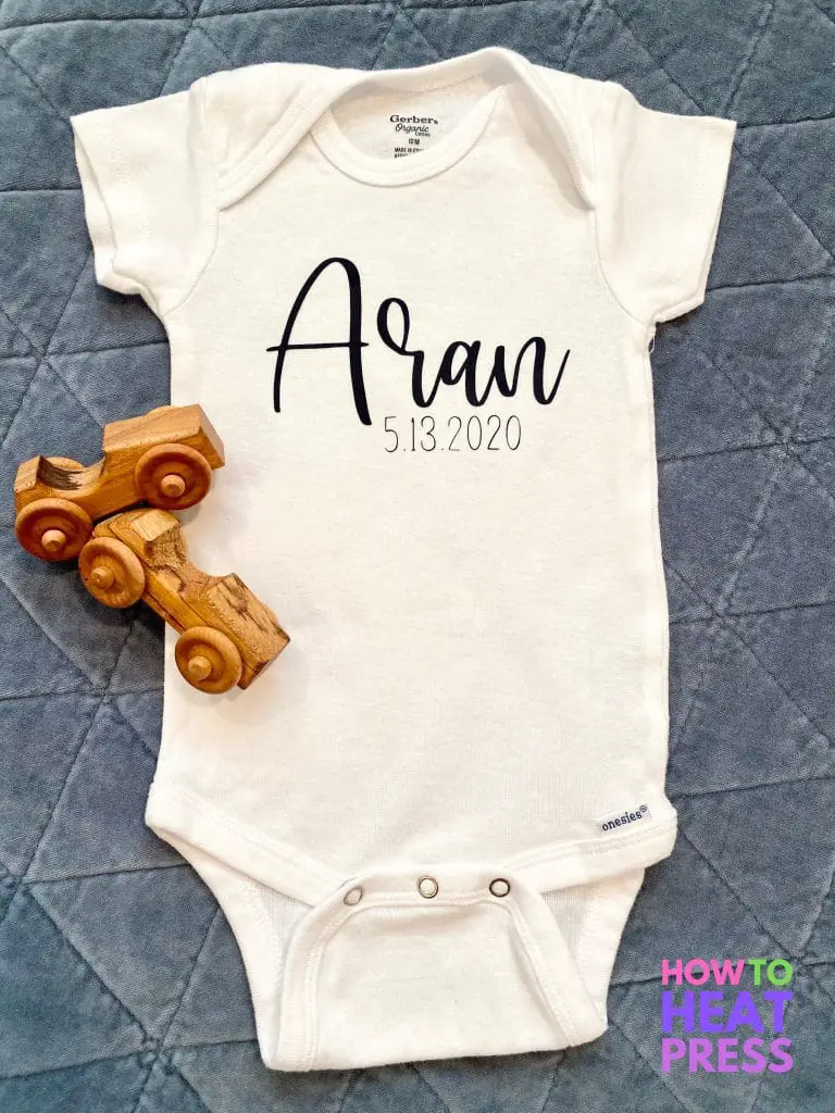 white gerber onesie with blue cursive name and date of birth