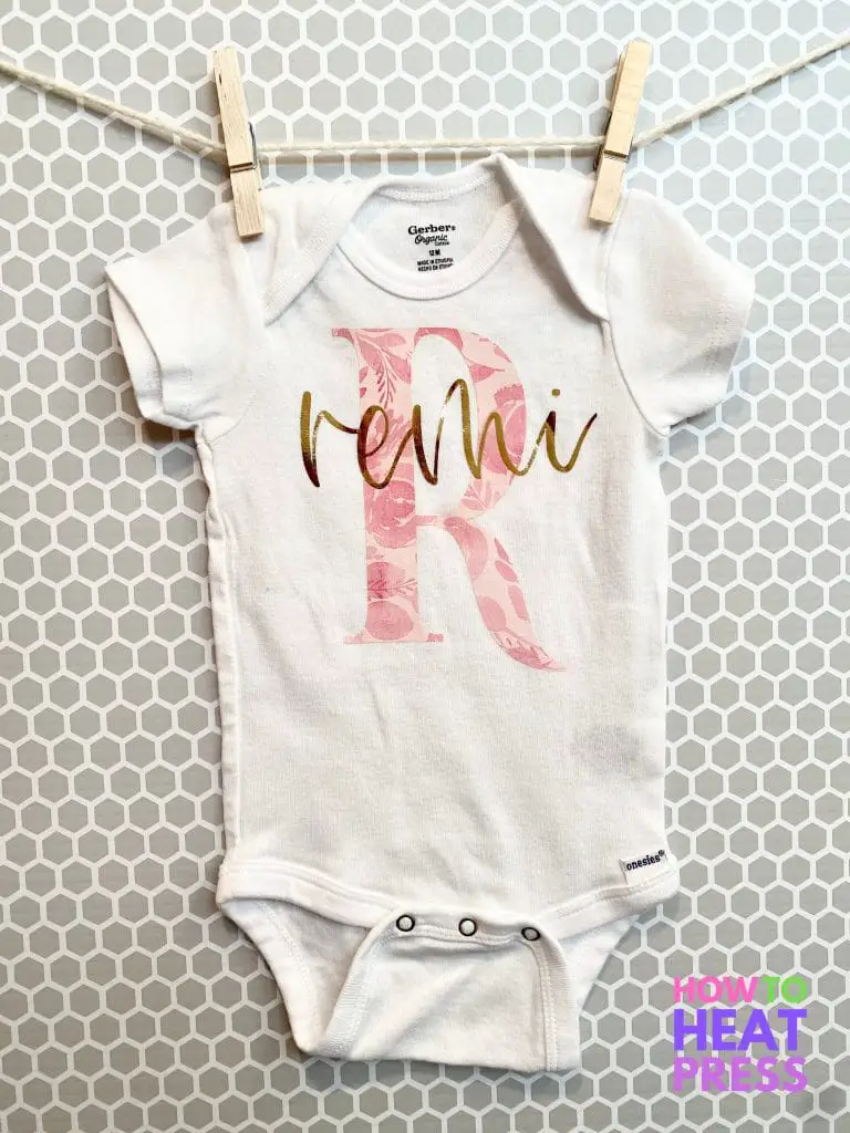 white onesie with pink floral patterned R and gold foil htv