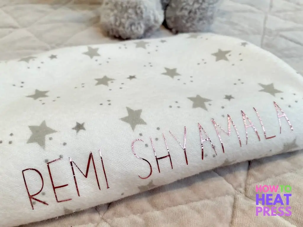 white receiving blanket with gray stars and custom pink baby name