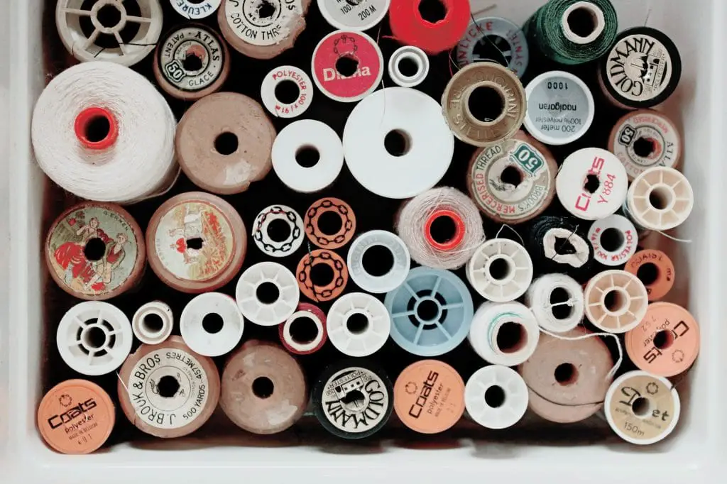 spools of thread in tan, red, and white