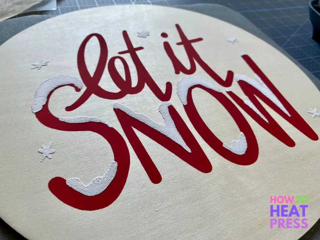 completed htv on wood 'let it snow' sign