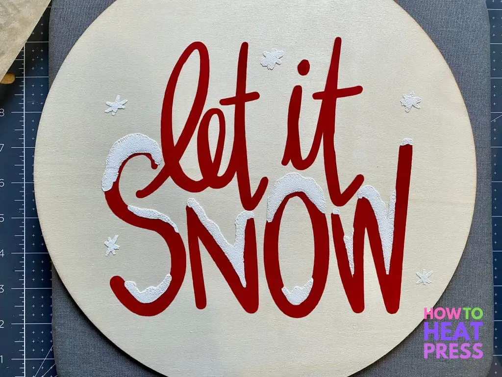 red letters with white snow in HTV on wood 'let it snow' sign